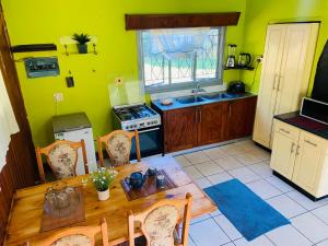 a kitchen with a table and a kitchen with yellow walls at Mountain View Escape in Mbabane