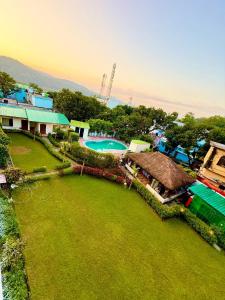 an aerial view of a resort with a swimming pool at Shelton Blu Resort in Rāmnagar