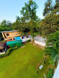 an aerial view of a yard with a house at Shelton Blu Resort in Rāmnagar