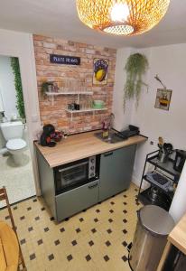 a kitchen with a sink and a counter top at Maison de la Liberté - Petite maison à 4 étages in Nyons +22 photos