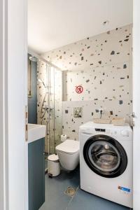 a bathroom with a washing machine and a toilet at Ether Rooftop Spa in Glyfada C47 in Athens