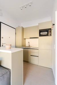 a kitchen with white cabinets and a sink at Ether Rooftop Spa in Glyfada C47 in Athens