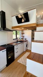 a kitchen with a sink and a stove top oven at Grace & Rose in Gibbston