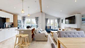 a kitchen and living room with a couch and a table at Unity Beach in Berrow