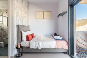 a bedroom with a bed with red pillows at Ether Rooftop Spa in Glyfada C47 in Athens