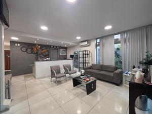 a living room with a couch and a table at Executivo Prime Hotel in Teresina