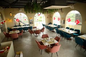 a dining room with tables and chairs and windows at Prince Palace And Banquet in Pāndharkawada