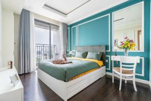 a bedroom with a bed and a desk with a chair at Apartment Luxury Center HCM City with Infinity Pool in Ho Chi Minh City +52 photos