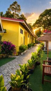a yellow building with a cobblestone street in front of it at Fiqthya Chalet & Cafe in Tioman Island