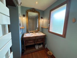 a bathroom with a sink and a mirror at Exceptional house with a pool in Jarrie +20 photos