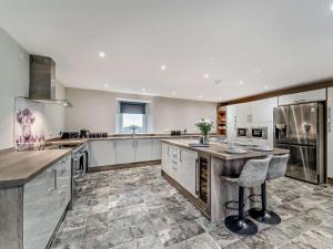 a large kitchen with white cabinets and a counter at 3 Bed in Girvan oc-96394 in Girvan