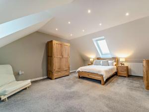 a attic bedroom with a bed and a skylight at 3 Bed in Girvan oc-96394 in Girvan +22 photos