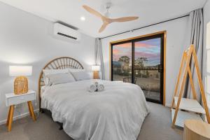 a bedroom with a bed with two towels on it at Three Ponds Estate in Temora