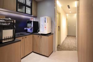 a kitchen with a microwave oven on a counter at Cityinn Hotel Taipei Station Branch I in Taipei
