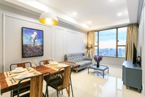 a dining room and living room with a table and chairs at Apartment Luxury Center HCM City with Infinity Pool in Ho Chi Minh City