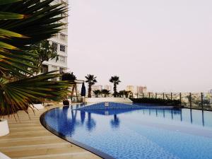 a large swimming pool next to a building at Apartment Luxury Center HCM City with Infinity Pool in Ho Chi Minh City