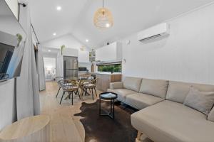 a living room with a couch and a table at Three Ponds Estate in Temora