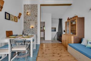 a living room with a table and a couch at Authentic Hideaway by Riva with Free Parking in Podgora