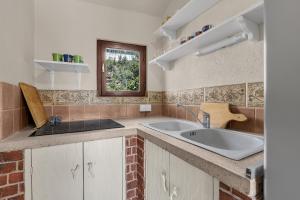 a kitchen with a sink and a window at Authentic Hideaway by Riva with Free Parking in Podgora +54 photos