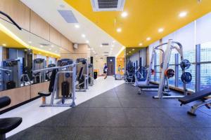 a gym with treadmills and machines in a building at Apartment Luxury Center HCM City with Infinity Pool in Ho Chi Minh City