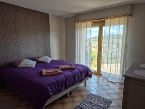 a bedroom with a purple bed and a large window at Villa Bellevue - Chez Oma in Wingen-sur-Moder