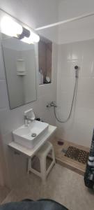 a bathroom with a white sink and a shower at Aegean Dream Room in Kamares +26 photos