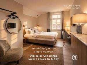 a hotel room with a bed and a mirror at The Townhouse Ruhpolding - Individual Design & Casual Concept - Chiemgau Karte in Ruhpolding