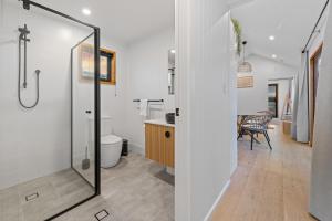 a bathroom with a shower and a toilet at Three Ponds Estate in Temora +51 photos