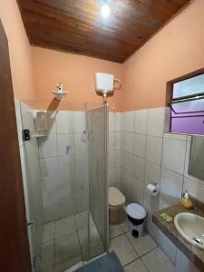 a bathroom with a shower and a toilet and a sink at Aconchego do céu in Conceição da Ibitipoca