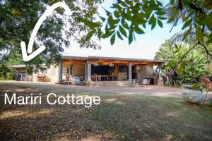 a home with the words martini cottage at Mariri Farm Cottage in Patentie