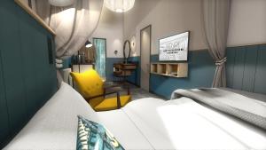 a bedroom with a bed and a yellow chair at HENRI Hotel Cuxhaven in Cuxhaven