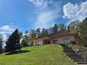 a house on top of a hill with stairs at Villa Bellevue - Chez Oma in Wingen-sur-Moder