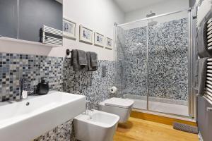 a bathroom with a toilet and a sink and a shower at C123 Luxury in Chiavari +34 photos