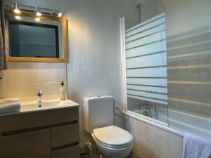 a bathroom with a toilet and a sink and a tub at Eurocéan Adonis Budget in Guérande +11 photos