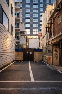 an empty parking lot in a city with tall buildings at Comfy & Cozy in Seoul