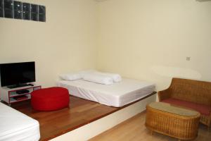 Säng eller sängar i ett rum på Green Leaf Guest House by Sinergi