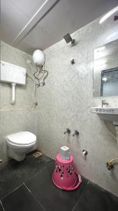 a bathroom with a toilet and a sink at Jazz residency hotel in Mumbai