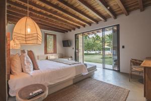 a bedroom with a large bed and a table at ICACO refugio de playa in Guachaca +40 photos