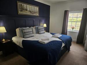 a bedroom with a large bed with towels on it at The Inn at Strathyre in Strathyre