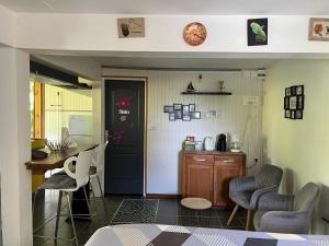 a room with a door and a table and chairs at Coconut Studio in Capesterre-Belle-Eau