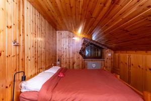 a bedroom with a bed in a wooden room at Ciasa Gaia in Mazzin