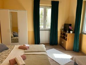 a bedroom with a mirror and a bed with towels at Apartment Bačvice in Split