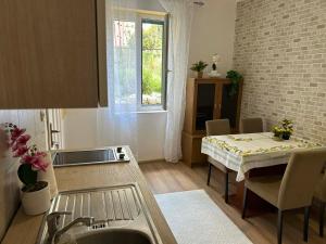 a kitchen with a sink and a table with a table cloth at Apartment Bačvice in Split +4 photos
