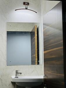 a bathroom with a mirror and a sink at Jazz residency hotel in Mumbai +18 photos