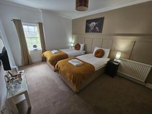 a bedroom with two beds and a window at The Inn at Strathyre in Strathyre +9 photos