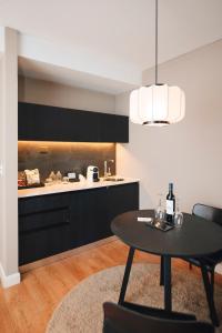 a kitchen with a table and a kitchen with a counter at CasaSur Bellini in Buenos Aires