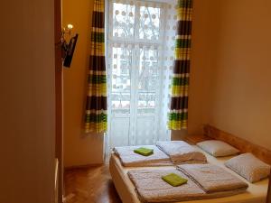 a bedroom with two beds in front of a window at Dream Hostel & Apartments in Krakow