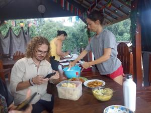 a group of people standing around a table with food at Tetebatu Terrace Homestay in Tetebatu