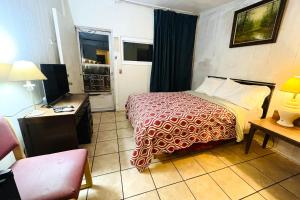 a hotel room with a bed and a television at Sparta Motel Near St Louis- Mississippi River IL in Sparta