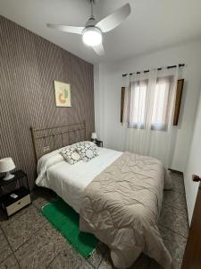 a bedroom with a bed and a ceiling fan at Fina beach in Nules